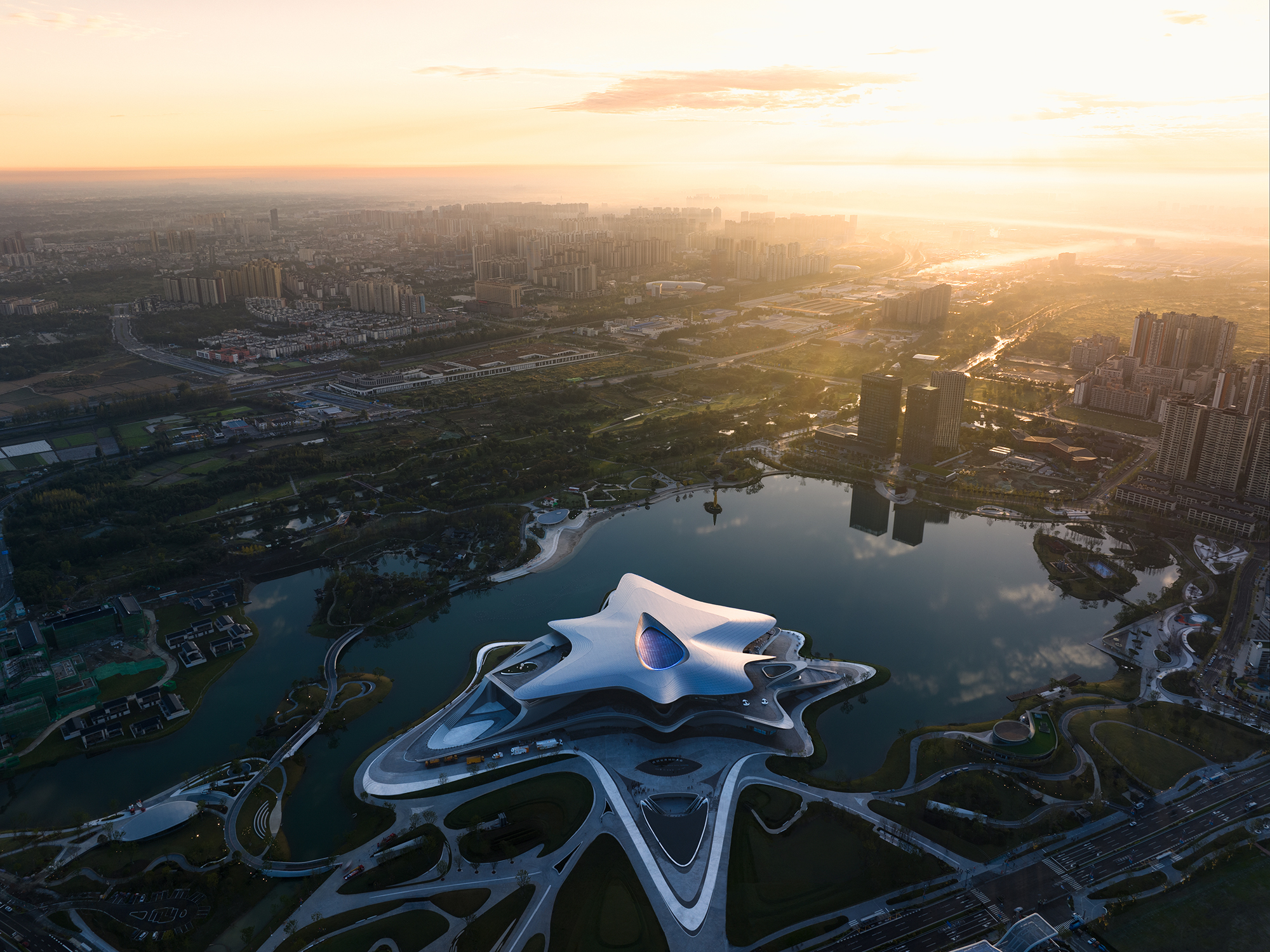 water-inspired architecture, riverfront buildings, urban design, modern Chinese architecture, tranquil environments, architectural aesthetics, public spaces, innovative structures, landscape and architecture, iconic projects