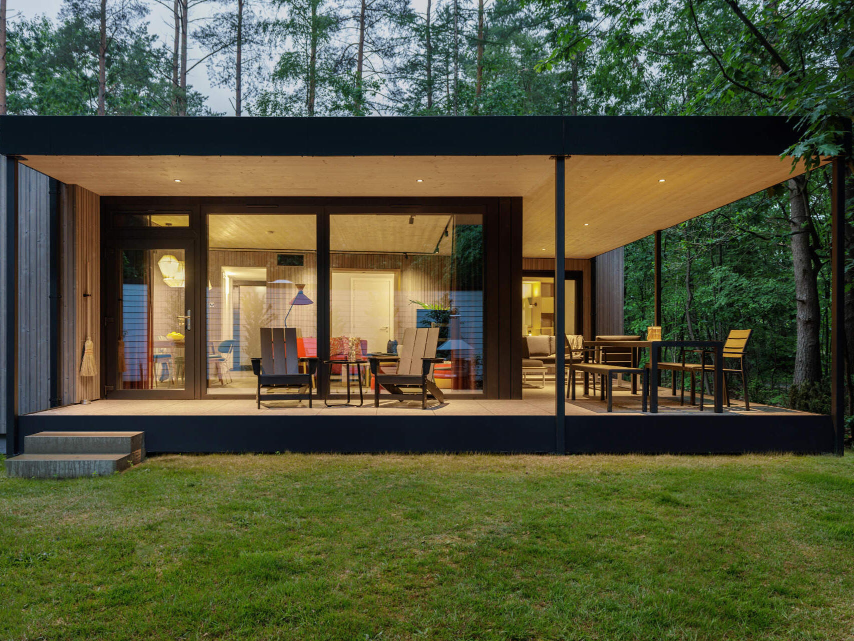 Step inside a modern prefab cottage where minimalist design and natural materials create a serene forest escape.