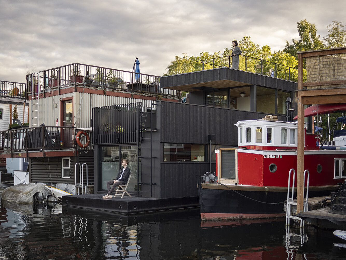 Vertical cedar siding, Richlite panels, and clear hemlock soffits give this floathome a refined, marine-ready exterior with architectural clarity.