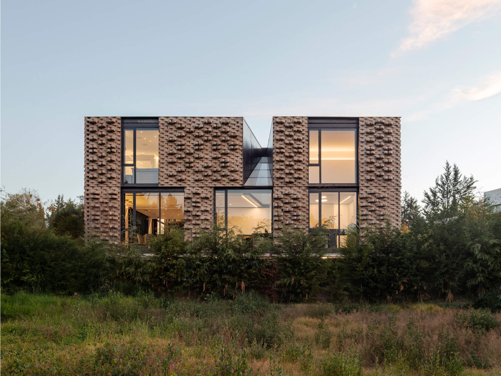 A modern home with a sculptural brick facade.