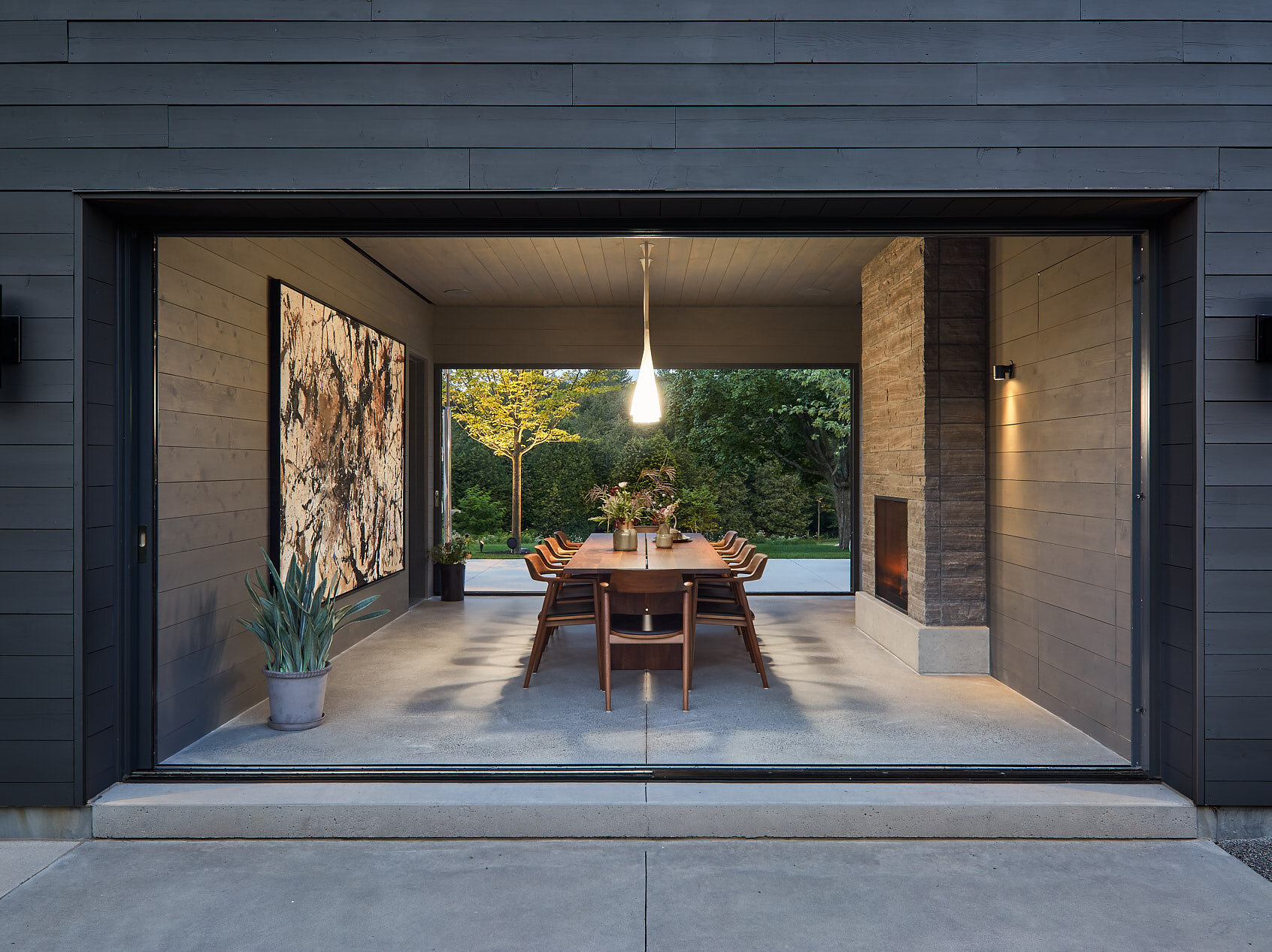 This modern farmhouse dining room doubles as a breezeway, seamlessly shifting between indoor elegance and outdoor airiness.