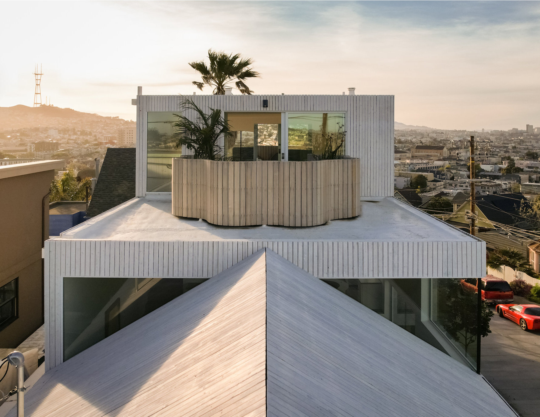 A former corner store is transformed into a bold yet sensitive family home, where sculptural geometry meets adaptive reuse. The standout circular window on the facade sets the tone for a design that’s both modern and rooted in place.