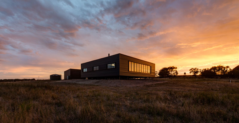 A prefab farm house on French Island wraps around a sunlit courtyard, offering sweeping water views and off-grid living.