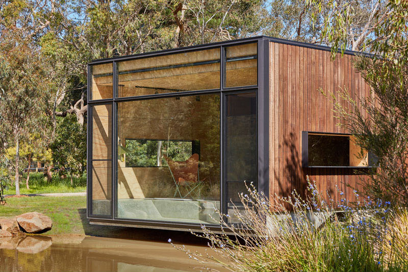 A serene retreat beside a pond that transforms from empty shell to yoga studio, reading room, or entertaining space.