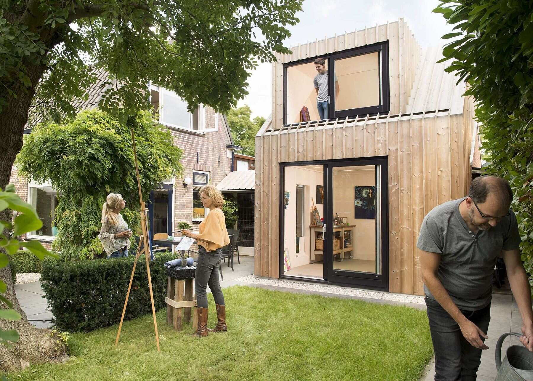 Old masonry walls and a new light wooden volume come together to create a warm, modern backyard art studio filled with natural light.