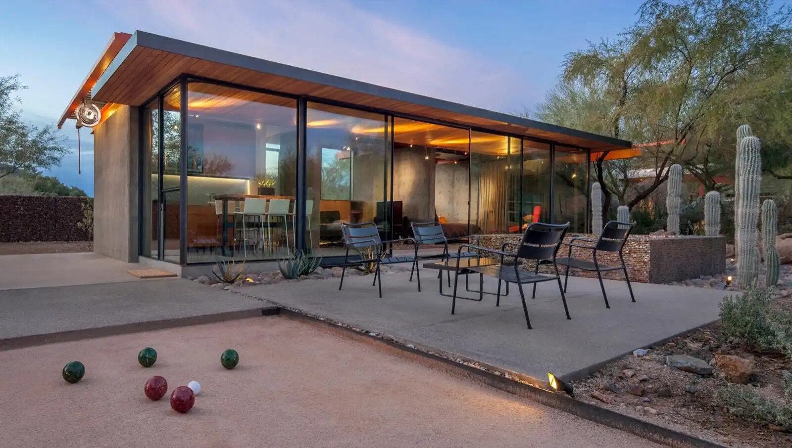 Once a working barn in Phoenix, this guest house by The Construction Zone features full-height glass, concrete, and Douglas fir details that highlight desert modernism.