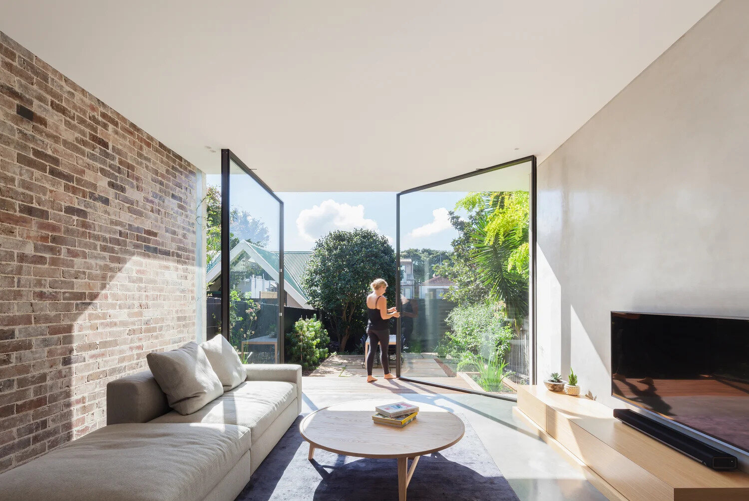 Minimalist glass pivot doors make bold architectural statements in modern interiors.