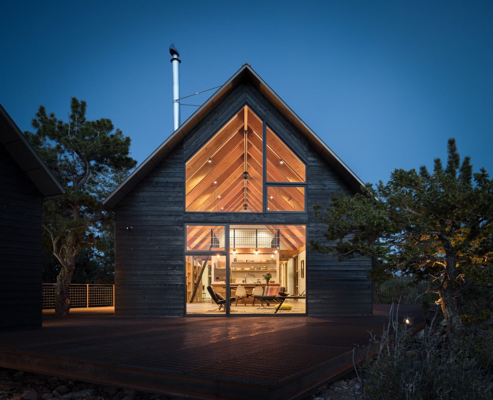 Dark stained cedar siding, gabled roofs, and expansive glass give these cabins a rustic yet refined style rooted in Colorado tradition.