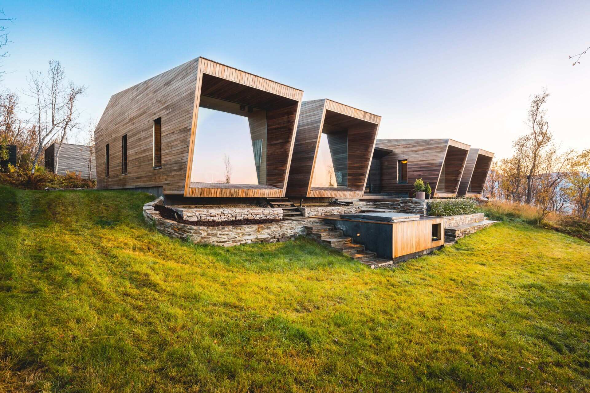 A clever layout of separate wooden volumes creates privacy and flexibility for a growing family.