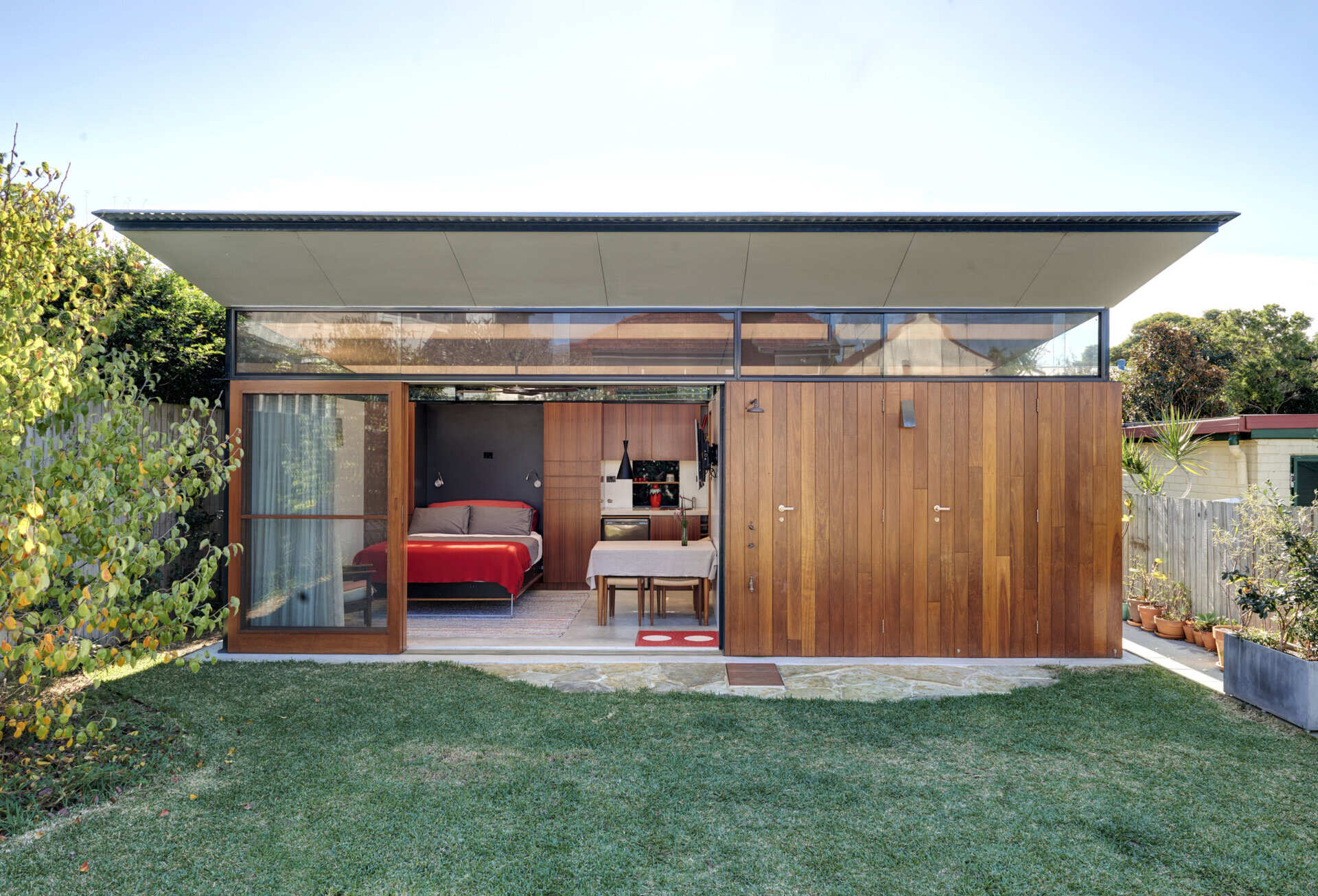 A small backyard studio that fits a living space, kitchenette, bathroom laundry, and workspace, all designed for flexible daily use.