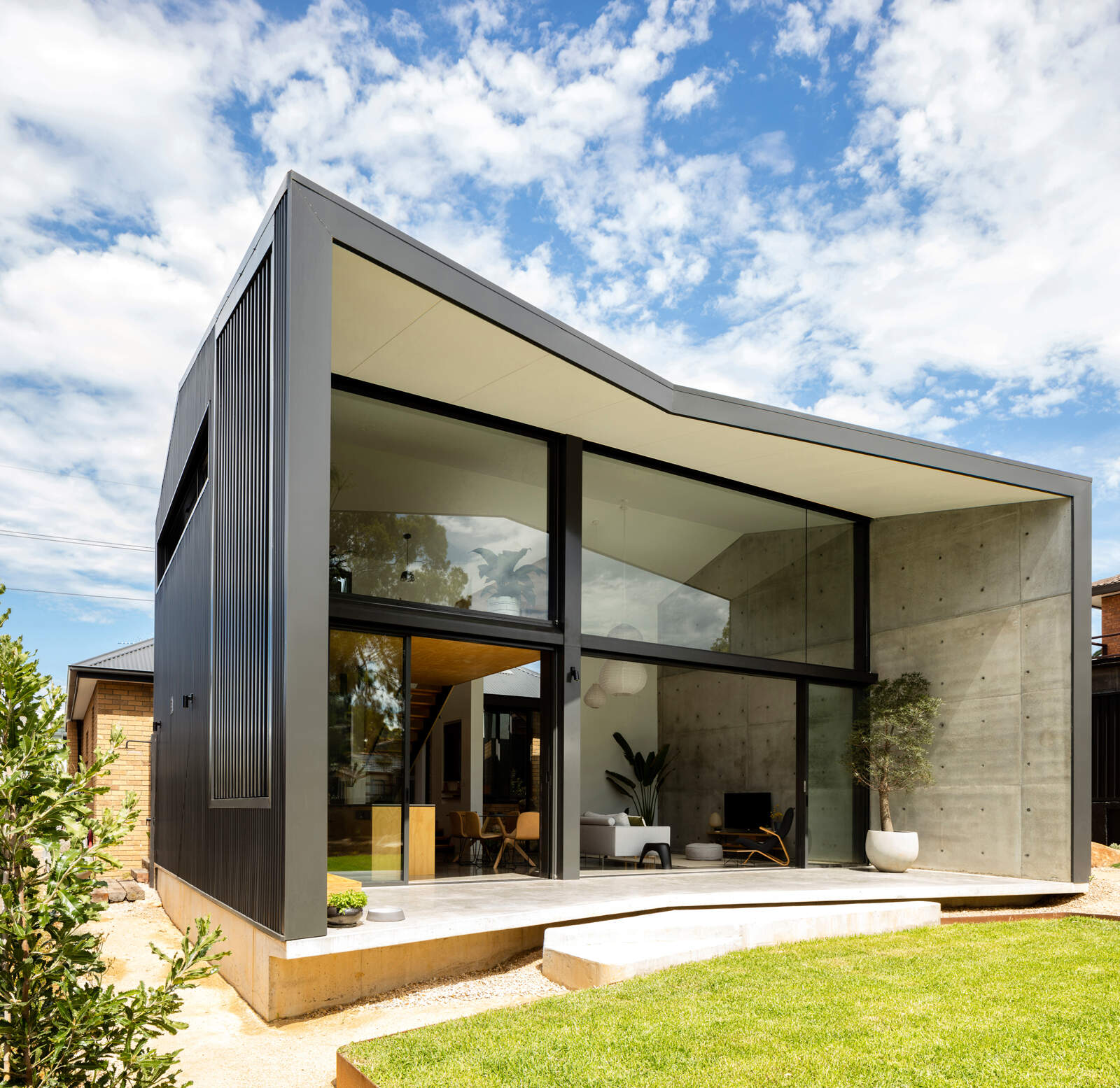 A modern extension on a 1960s yellow brick house in Australia.