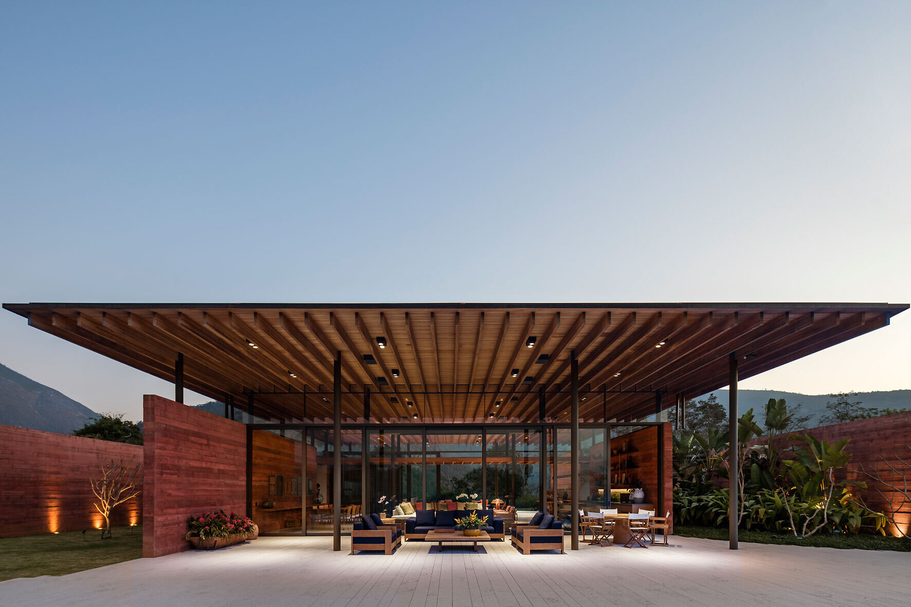 The exterior of Casa Terra shows how pigmented concrete walls become the defining feature of this modern Brazilian home by Bernardes Arquitetura.
