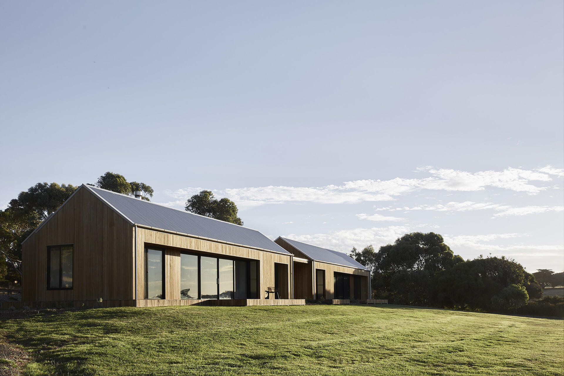 A serene coastal retreat replaces a 70s kit home with a modern family sanctuary that feels grounded in the landscape.