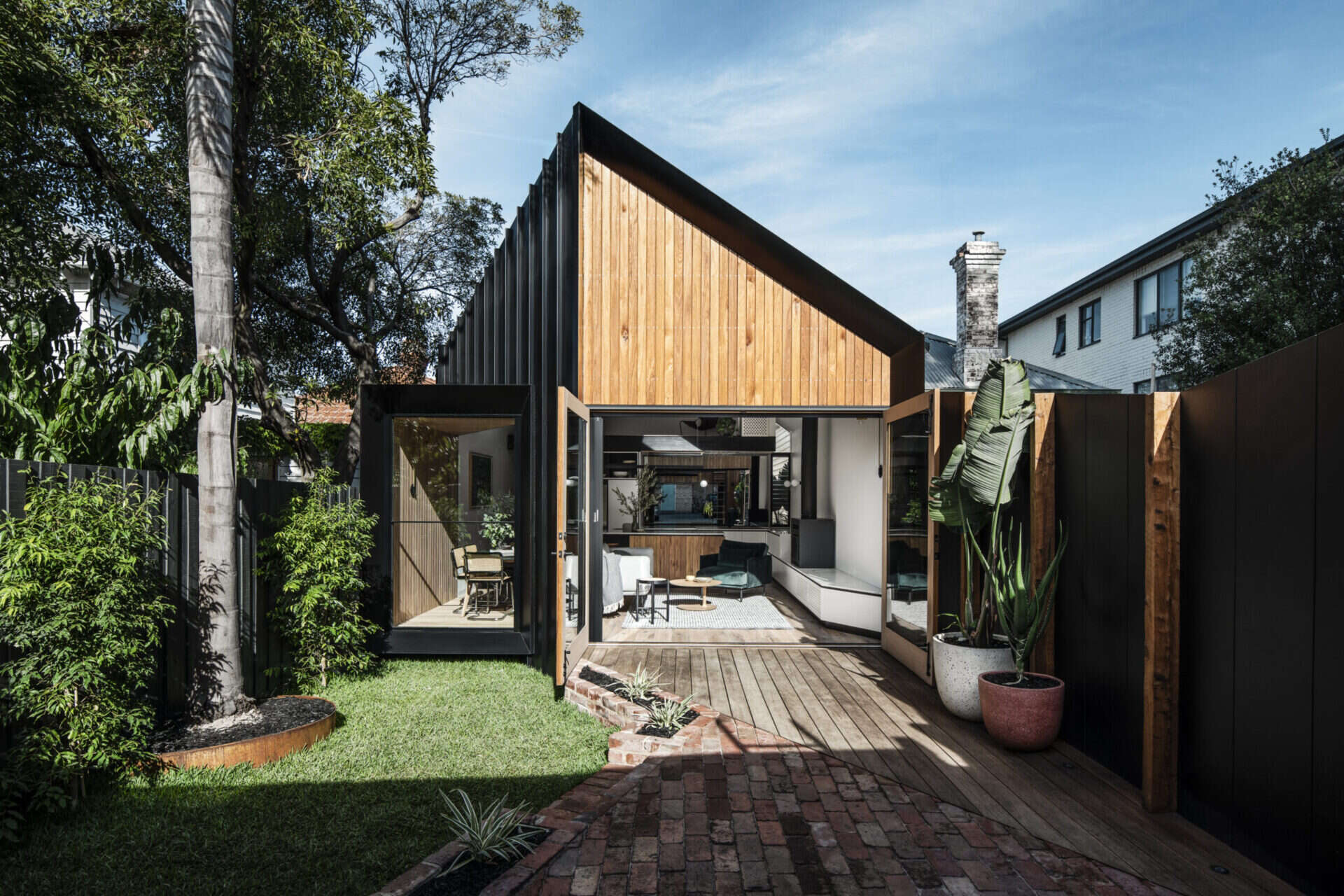 A modest Melbourne home has an extension that reveals a dramatic vaulted interior designed to maximise light on a narrow block.