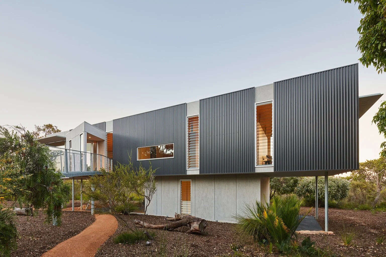 This elevated Australian home is clad in durable, bushfire-resistant finishes of Colorbond, steel, cement and spotted gum.