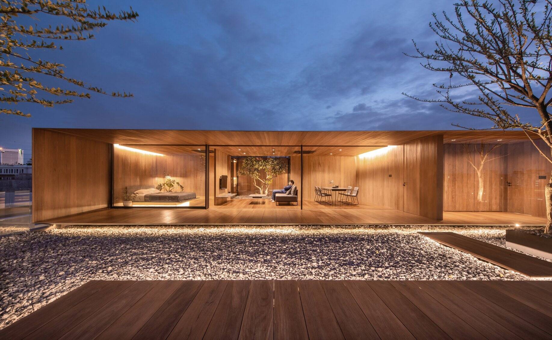 A Bangkok rooftop once used only for water tanks has been transformed into a warm and private wooden home by WARchitect.