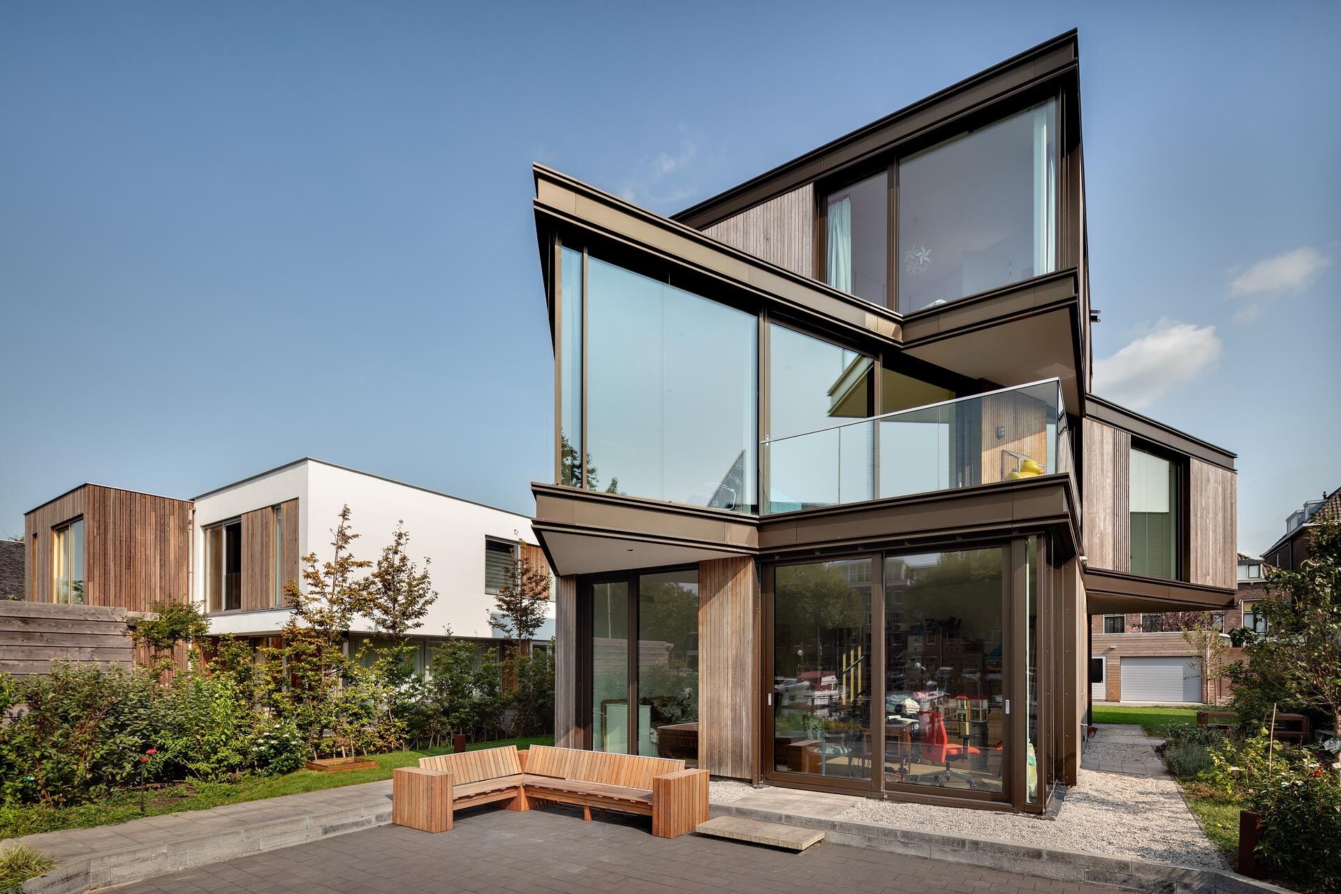 This modern villa in Schiedam features three stacked rectangular floors, with the middle level rotated to create a striking angular form. Wood, metal and glass reference the site’s industrial past while adding a subtle maritime touch.