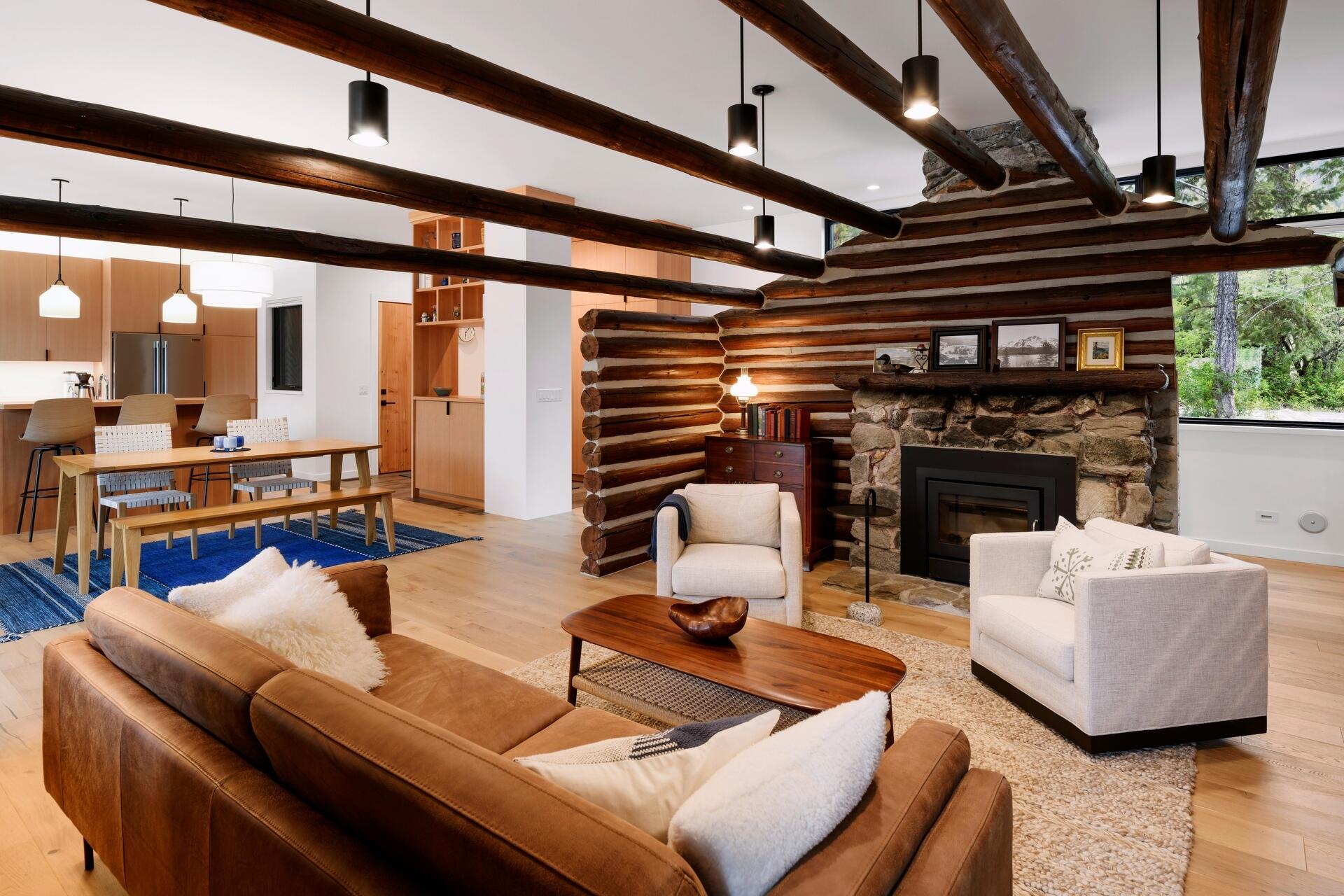 A modern lake house on Lake Wenatchee is built entirely around a preserved 1915 log cabin, turning history into the home’s centerpiece.