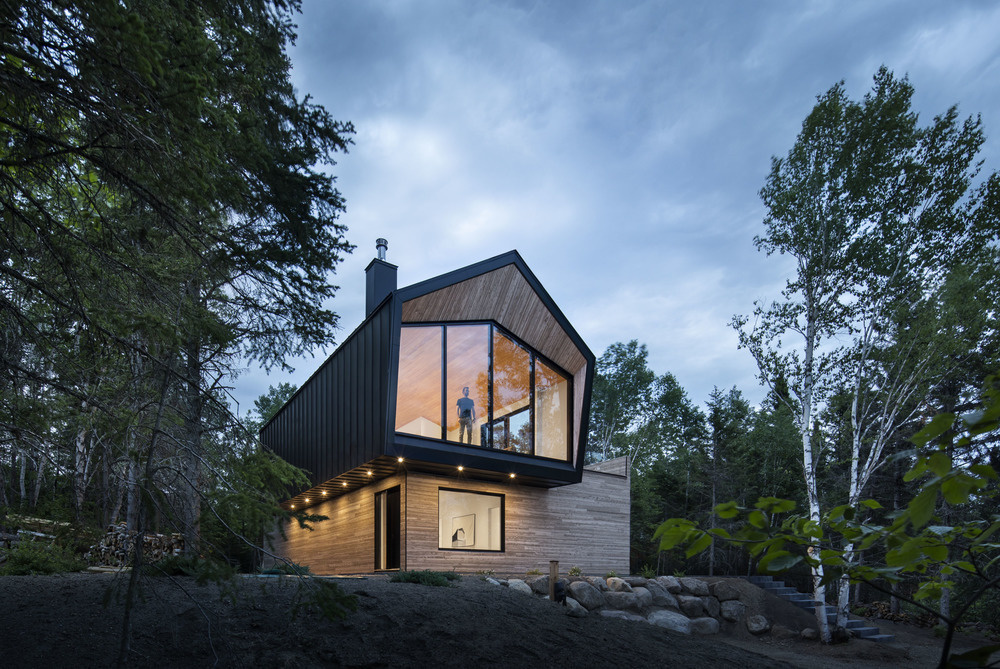 This Quebec home in Charlevoix blends minimalist design with breathtaking St. Lawrence River views for a serene retreat.